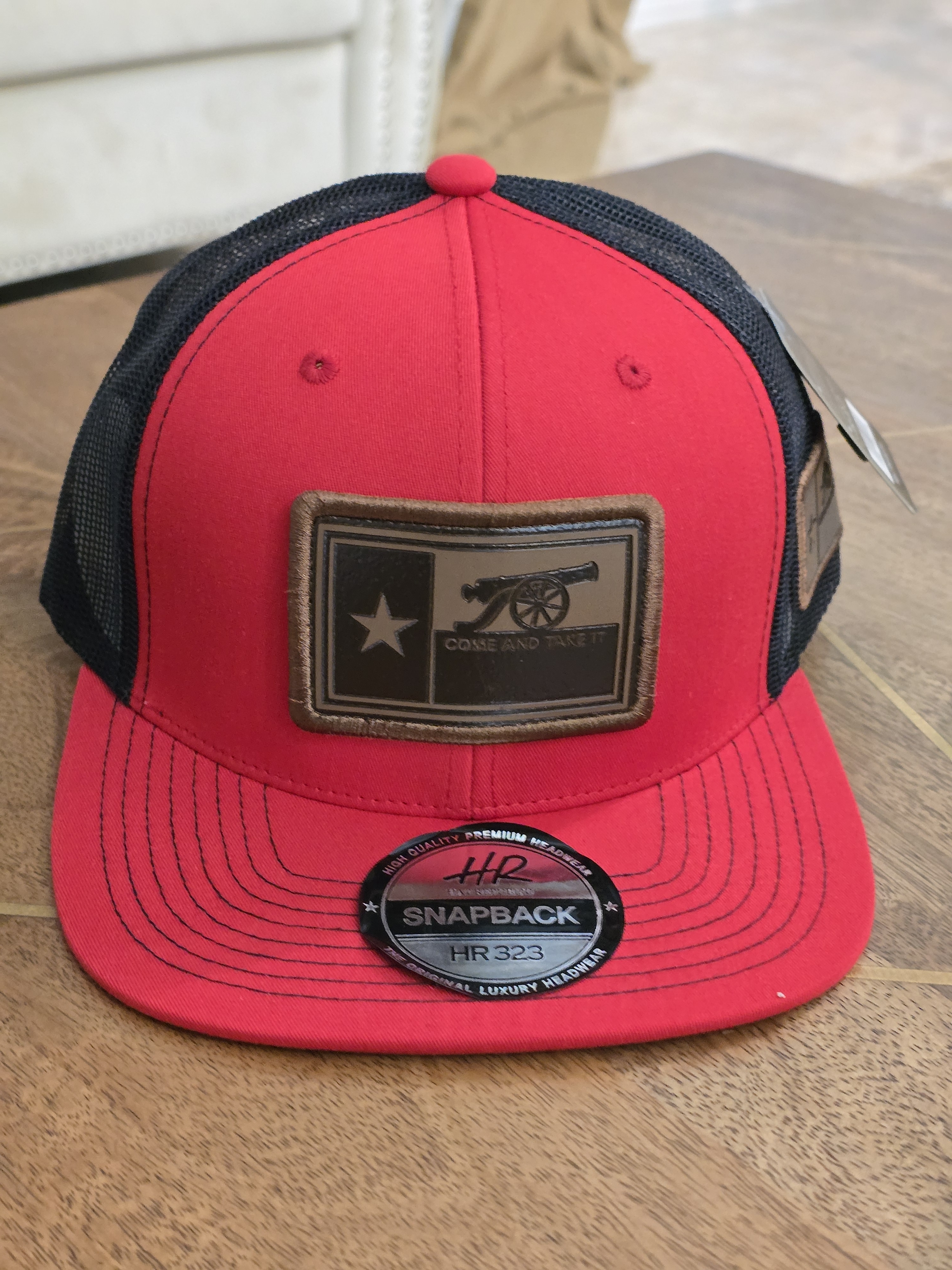 Red And Black Snapback Cap With Cannon Patch